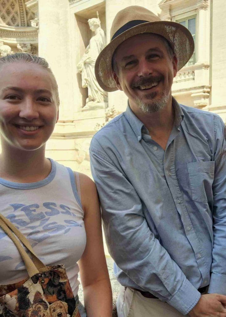 a student with Professor James Arthur at the Trevi Fountain in Rome