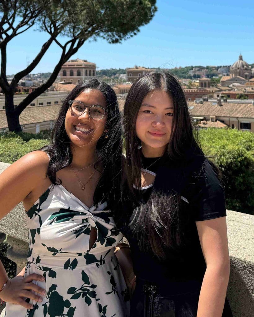 two students standing on a balcony above the Palazzo Colonna