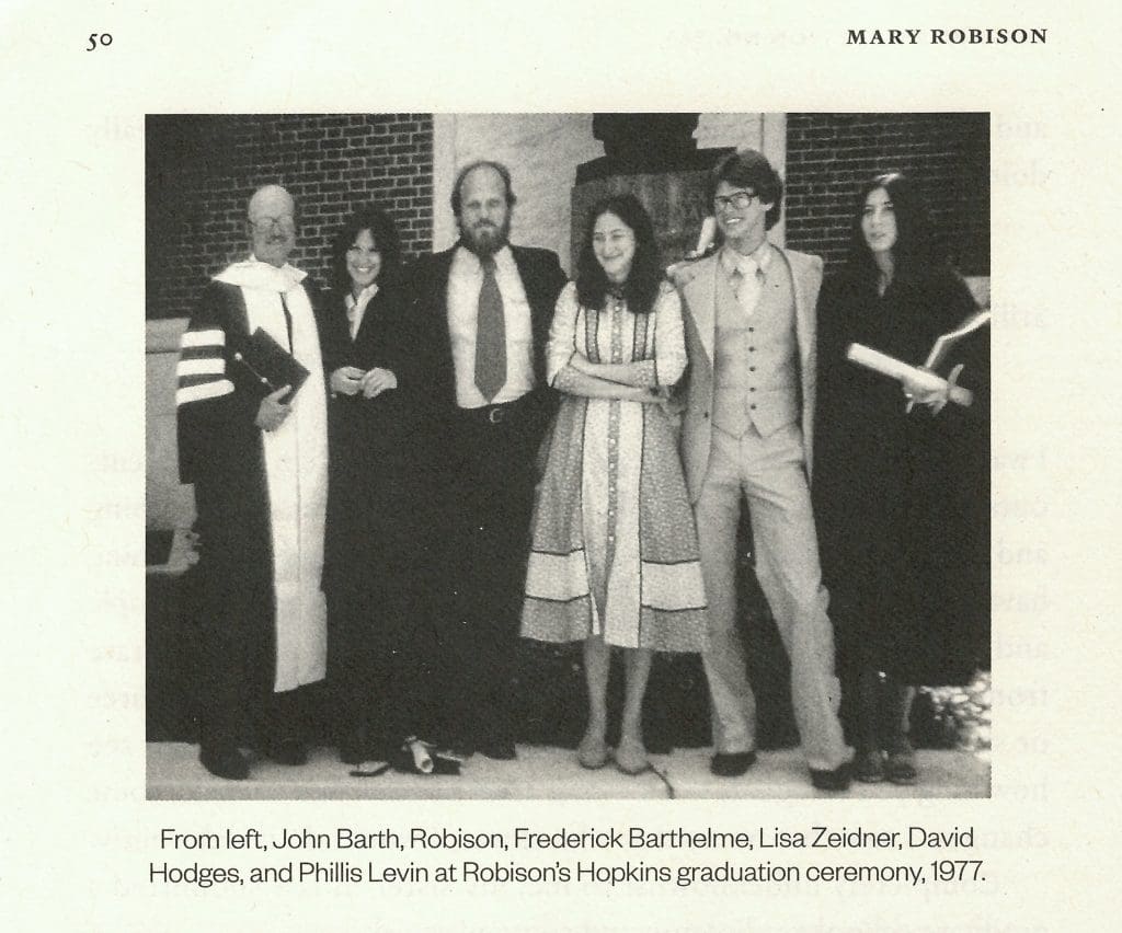 Photograph of Mary Robison's graduation day from the Writing Seminars in 1977. Pictured from left are: John Barth, Mary Robison, Frederick Barthelme, Lisa Zeidner, David Hodges, and Phillis Levin. The photo is in black-and-white.