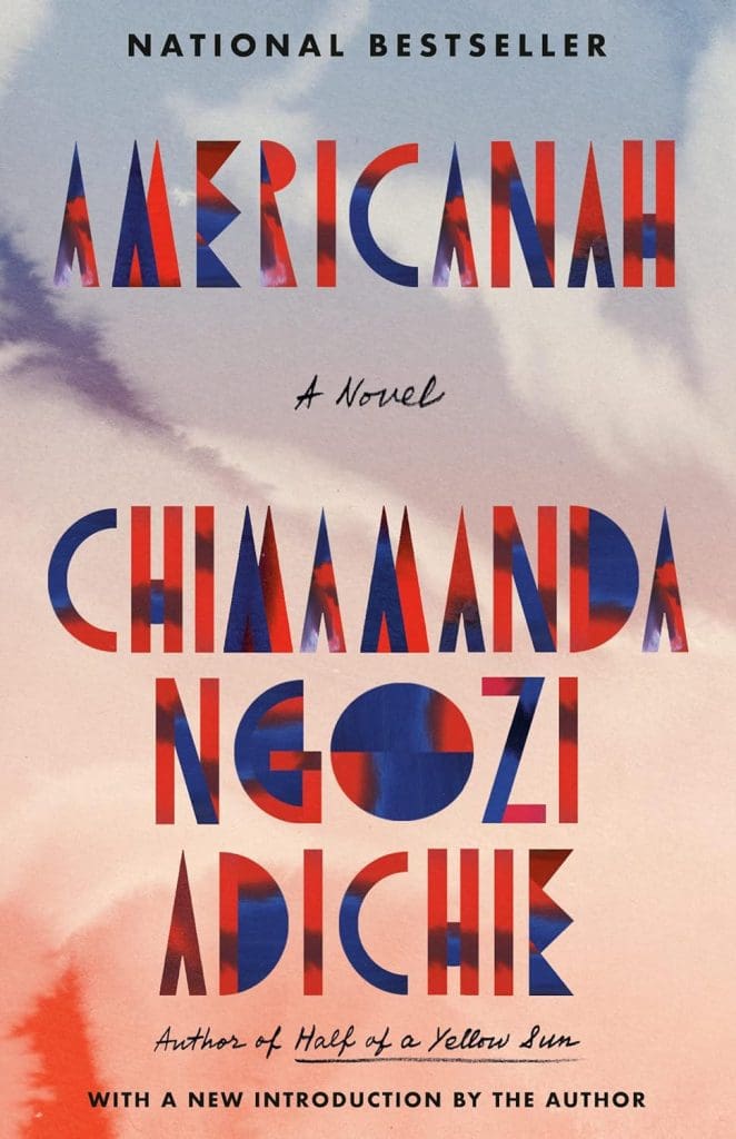 AMERICANAH by Chimamanda Ngozi Adichie. Cover is subtle hues of red, white, and blue, and depicts a watercolor-like gradient of the colors in a pattern that looks like clouds and sky. 